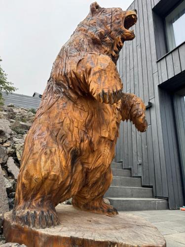a statue of a brown bear with a baby bear at Luxury Chalets Lesná in Nová Lesná