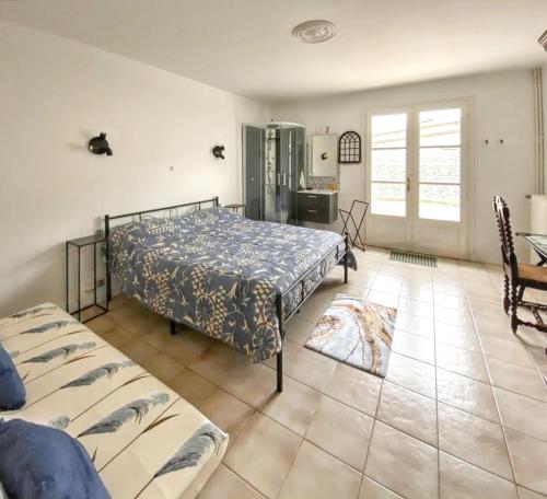a bedroom with a bed and a table and chairs at Maison confortable avec piscine près de La Ville-Dieu in La Ville Dieu du  Temple