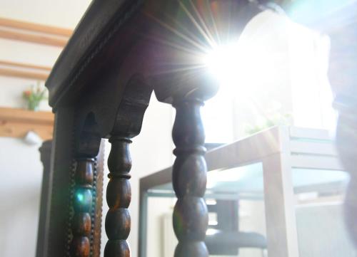 a stair case with the sun shining through a window at Gästehaus Wagner in Chemnitz