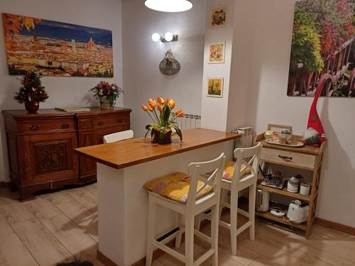 a kitchen with a island with two chairs and a table at Casa Vacanze Ada in Fiesole
