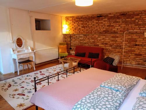 a bedroom with a bed and a brick wall at Boho-Style-Apartment in Sankt Veit an der Glan