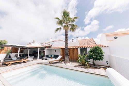 a villa with a swimming pool and a house at Villa in Comporta Village with heated pool in Comporta