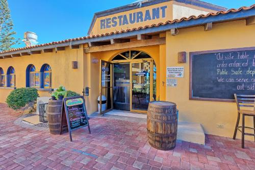 a restaurant with a sign in front of a building at Right on the Beach! Ocean Front 2 Story Penthouse in Puerto Peñasco