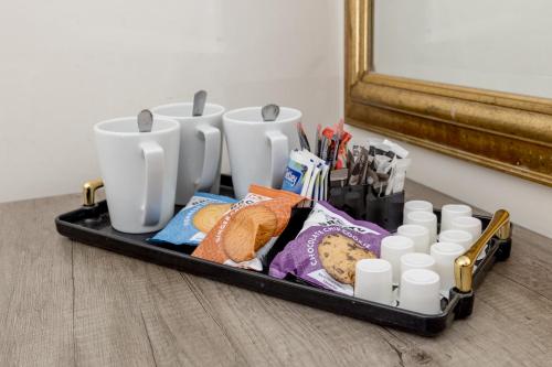 a tray with a group of cups and other items at The Stair Arms Hotel in Edinburgh