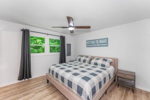 a bedroom with a bed and a ceiling fan at TB-13 Thunder Bay Resort Cabin 13 in Phelps