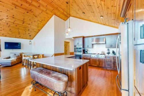 a kitchen with a large island in the middle of a room at Lakeside Lookout Little Arbor Vitae Lakes in Woodruff
