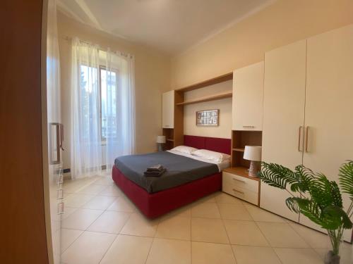 a bedroom with a bed and a plant in it at Casa Elena - Centro Diano Marina in Diano Marina