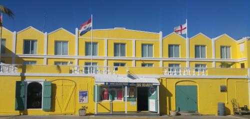 a large white building with a flag on top of it at Caravelle Hotel in Christiansted