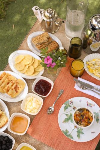 a table with plates of food on a table at Jenan Mayshad Marrakech, Boutique hotel with Pool & Private Padel Court in Marrakech