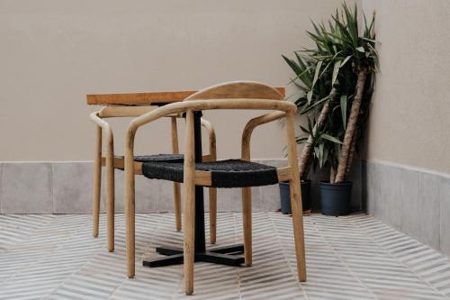 a wooden chair sitting on top of a floor at Hotel & Spa Convento San Francisco in Soria