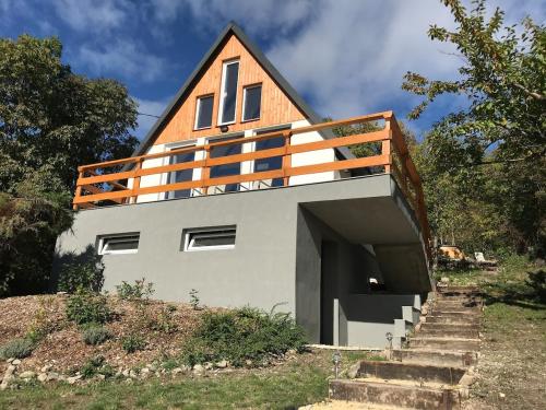 a house on top of a hill with stairs at Panorama Wooden Cabin - Hot Tub in Szentendre