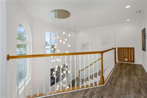 a staircase in a home with white walls and wood floors at Villa Azule in Clearwater Beach