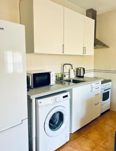 a kitchen with a washing machine and a sink at Casa Martins Country Apt No 4 in Freiria