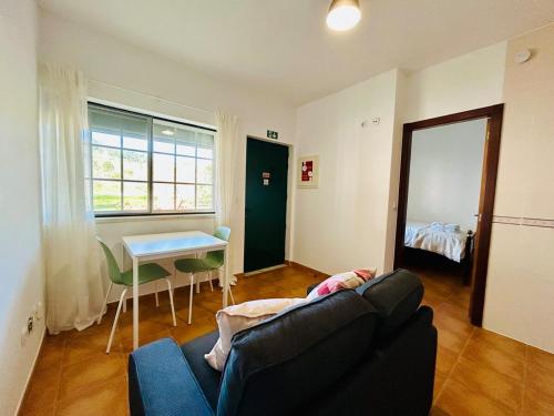 a living room with a couch and a table at Casa Martins Country Apt No 4 in Freiria