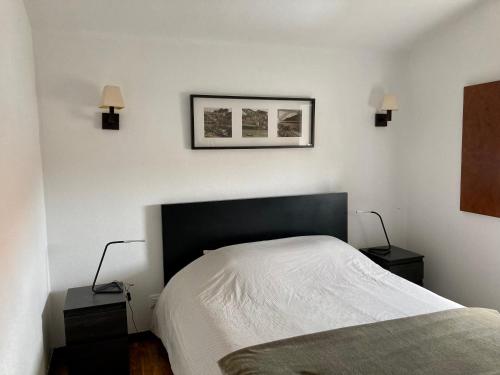 a bedroom with a bed with two night stands and two lamps at Maison traditionnelle Areosa in Viana do Castelo