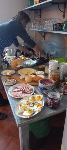 a table with plates of food on it in a kitchen at WILLA MONTE NEVE in Stronie Śląskie