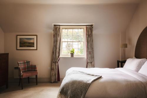 a bedroom with a bed and a window at The Pilsley Inn - Chatsworth in Baslow