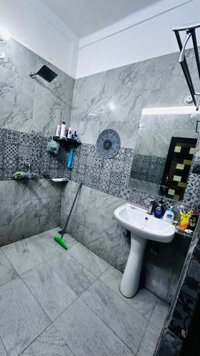 a bathroom with a sink and a mirror at Double room with balcony in Prayagraj