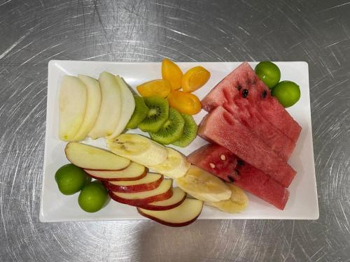 a white plate with fruits and vegetables on it at Gizli Cennet Villages Hotel in Fethiye