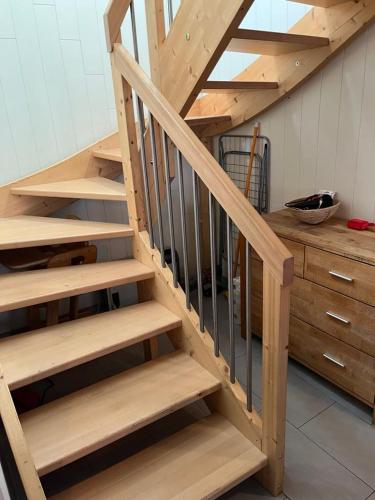 a wooden stairs in a room with a wooden cabinet at Historische Maisonettewohnung bis 10 Gäste, Magic Pass Belalp, Rosswald und mehr in Naters