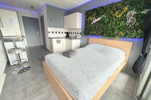 - une chambre dotée d'un lit avec un mur vert dans l'établissement Naturiste Cap d'Agde Héliopolis F 47, au Cap d'Agde