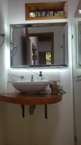 a bathroom sink with a large mirror above it at Hotel Campestre Villa Nico in Bochalema