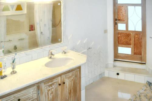 a bathroom with a sink and a mirror at Elegant House with Sea View in Cannigione in Cannigione