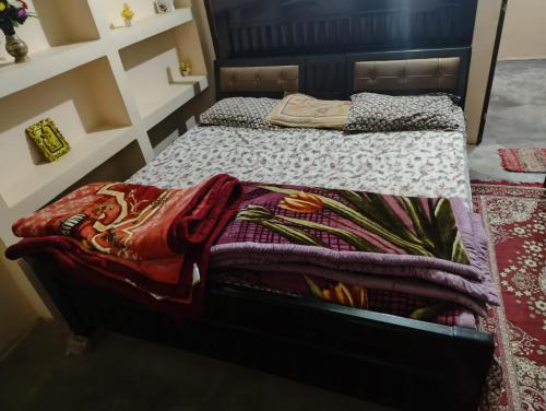 a bedroom with a bed with a blanket on it at Serene Neo Home Stay in Prayagraj
