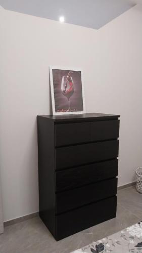 a black dresser with a picture of a flamingo on it at Il Calice dell'Etna in Passopisciaro