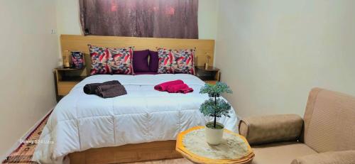 a bedroom with a bed and a couch and a table at cozy Apartment Near Airport in Marrakech
