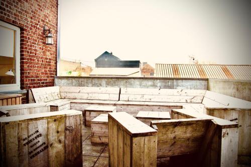an empty classroom with wooden tables and a window at Le Sabot in Nassogne