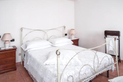 a bedroom with a white bed and two night stands at Charming House in Amelia with Lake View, 200 m² in Amelia