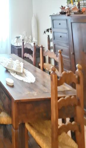 a wooden table with chairs and a wooden dining room at Charming House in Amelia with Lake View, 200 m² in Amelia