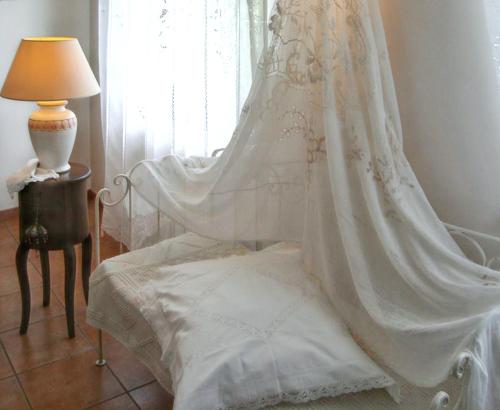 a wedding veil hanging over a bed next to a window at Charming House in Amelia with Lake View, 200 m² in Amelia