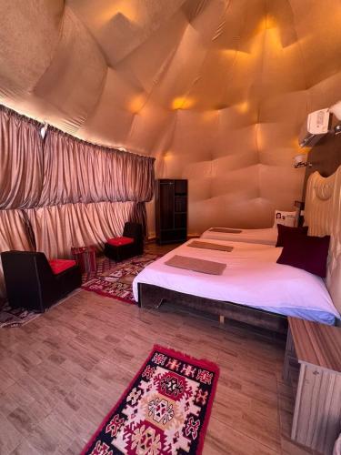 a bedroom with two beds in a tent at Wadi Rum Marina Camp in Wadi Rum