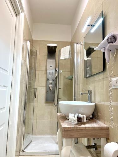 a bathroom with a sink and a shower at Certosa Suite in Naples