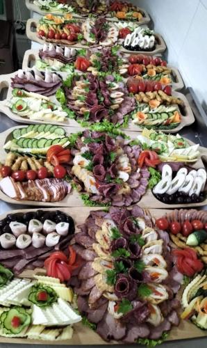 a bunch of different plates of food on a table at Pensiunea Rozmarin in Borca