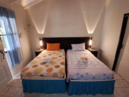 a bedroom with two beds in a room at Mom's Place Negril in Negril