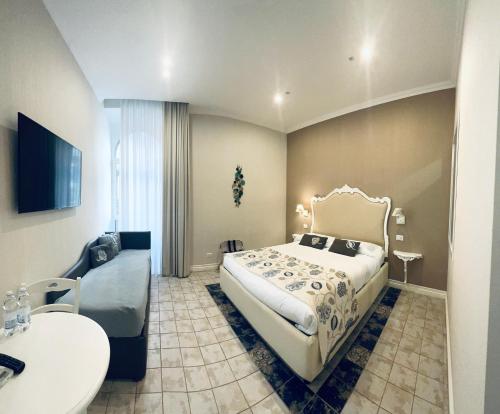 a hotel room with a bed and a couch at Certosa Suite in Naples