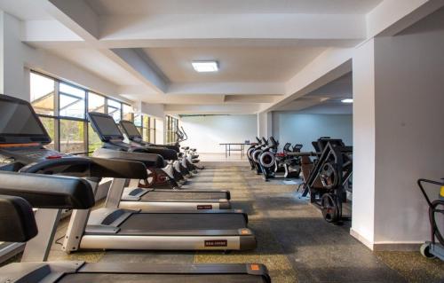 a gym with rows of treadmills and machines at Minstan towers in Nairobi