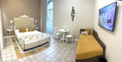 a bedroom with a bed and a table and chairs at Certosa Suite in Naples