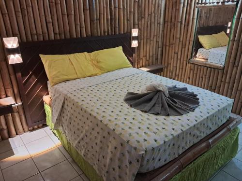 a bed with a dress on it with a mirror at Mom's Place Negril in Negril