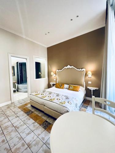 a bedroom with a bed and a table in it at Certosa Suite in Naples