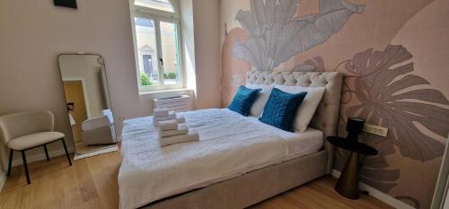 a bedroom with a bed with a flower mural on the wall at Luxury Nobile Apartment with private parking in Opatija