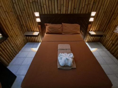 a bed in a small room with a bedvisor at Mom's Place Negril in Negril