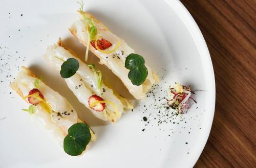 a white plate with three food items on it at Grand Hotel Victoria concept & spa, by R Collection Hotels in Menaggio