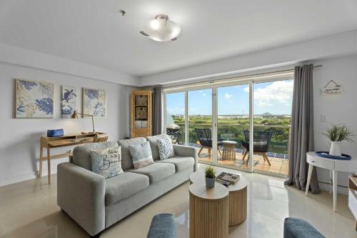 a living room with a couch and a table at Eagle Beach-Best value-Island View 1BR condo-R362 in Palm-Eagle Beach