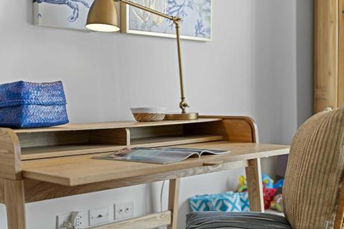 a desk with a lamp and a book on it at Eagle Beach-Best value-Island View 1BR condo-R362 in Palm-Eagle Beach
