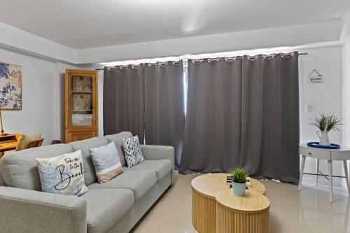 a living room with a couch and a table at Eagle Beach-Best value-Island View 1BR condo-R362 in Palm-Eagle Beach
