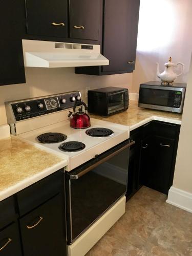 a kitchen with a stove and a microwave at Historic Upstairs Apartment in Bellevue